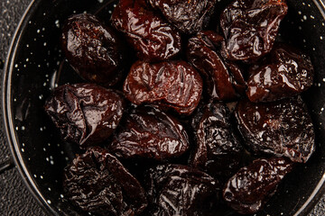 Prunes smoked plum portion size natural product tasty snack fresh delicious gourmet food background on the table rustic top view copy space keto and paleo diet vegetarian and vegan food