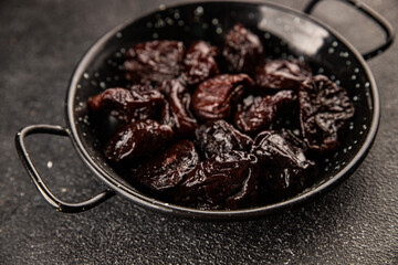 Prunes smoked plum portion size natural product tasty snack fresh delicious gourmet food background on the table rustic top view copy space keto and paleo diet vegetarian and vegan food