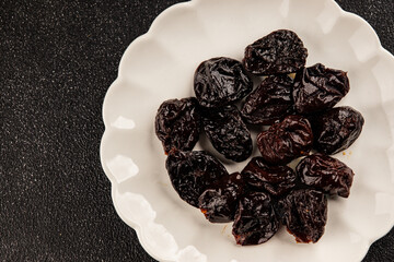 Prunes smoked plum portion size natural product tasty snack fresh delicious gourmet food background on the table rustic top view copy space keto and paleo diet vegetarian and vegan food