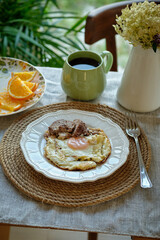 Breakfast. Fried eggs, turkey. Orange slices, tea.