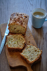 Cinnamon apple cake (bread) on a wooden table. A piece of cake.