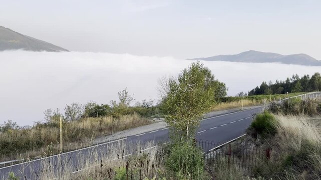 Leitariegos Pass, in Asturias, covered in fog with the mountains in the sun