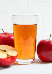 apple juice from red apples on the table.. Vertical photo format 