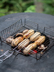 BBQ sausages in a grill basket outdoors