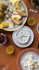 a table set with camembert cheese and snacks