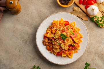 bowties pasta with Meat Sauce,Easy Farfalle with a simple tomato sauce with ground pork and beef in white plate.bolognese pasta.Top view.