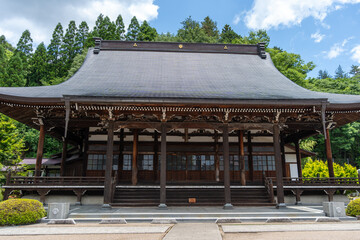 Sakurayama Hachimangu Shrine buildings surrounded by tall trees in Takayama, Japan