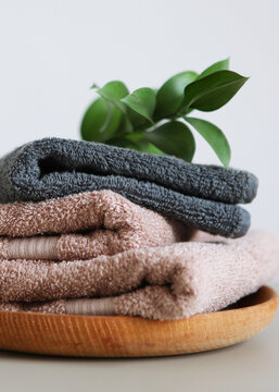 a stack of fresh towels on the table.. Vertical photo format