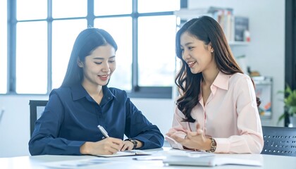 Fototapeta premium Two women collaborating in an office setting