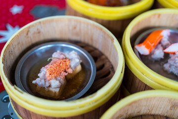 Steamed dumplings in a bamboo steamer basket. Close up