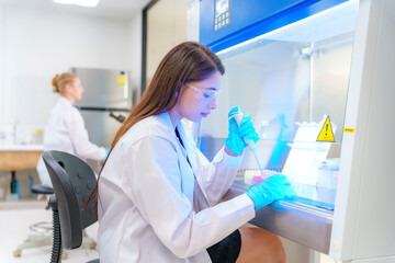 Laboratory technician conducting experiments with precision in a modern lab environment