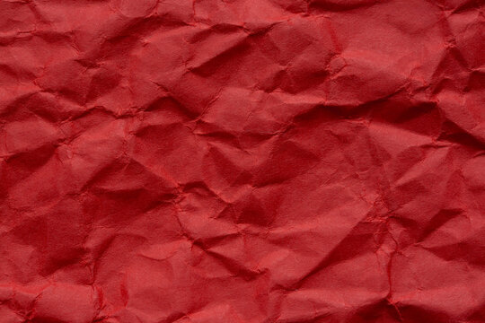 Close-up macro of wrinkled red paper texture,Red crumpled paper macro,dark red background of crumpled paper, free space for text. - Powered by Adobe