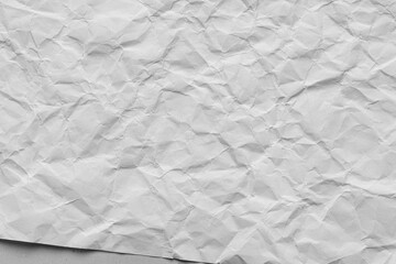 Naklejka premium Close-up macro of crumpled white paper texture,Wrinkled and crumpled white paper texture. Perfect as a background for design, art, and creative projects.