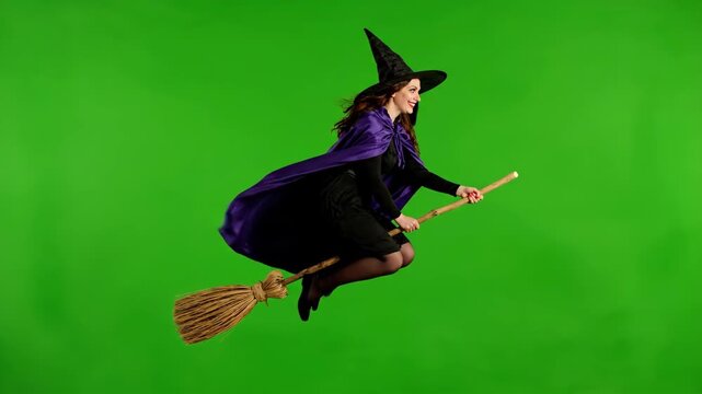 Woman Dressed as a Witch Flies on a Broomstick in Front of a Green Screen During Halloween
