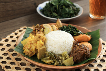 Nasi Padang with Rendang, Sambalado, Jackfruit Curry Stew, and Stuffed Squid Curry.