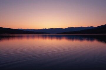 Serene Sunset Over Calm Lake with Majestic Mountain Reflections