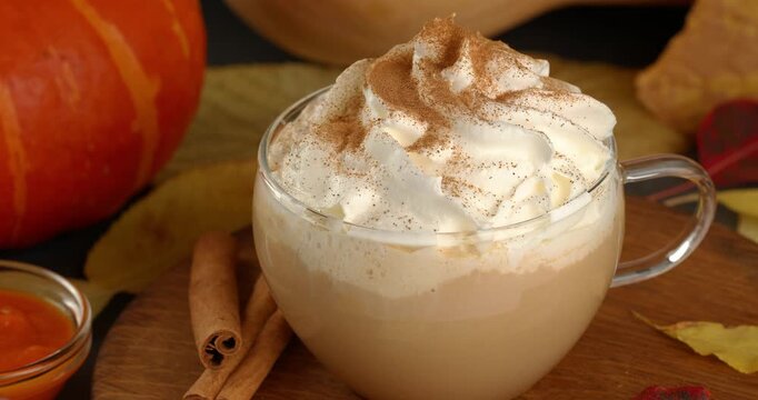 Process of making a pumpkin spice latte. Glass of pumpkin latte sprinkled with spices.