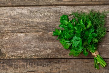 Dill and parsley on the texture table. Mixed bunch of fresh parsley and dill. Fresh aromatic spicy greens. Spices and herbs. Space for text. Copy space