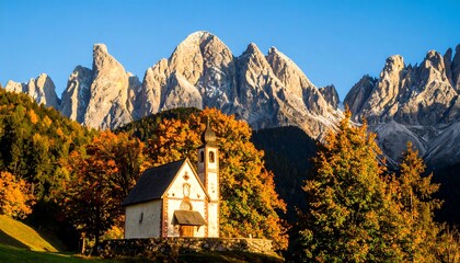 Alpine chapel at autumn sunrise