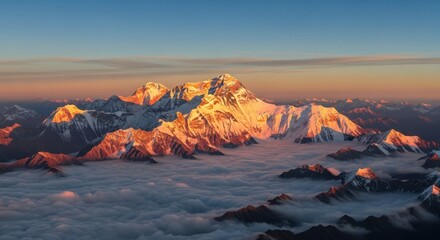 Fototapeta premium Majestic mountain peaks bathed in golden sunrise light above clouds snow rock