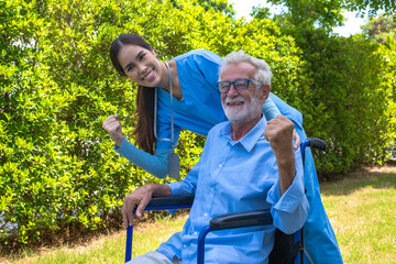 Asian female caregiver taking care of male elderly pensioner in homecare