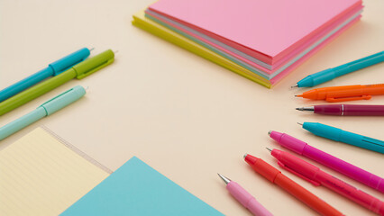 Obraz premium Colorful Stationery with Pens and Notepads on a Desk