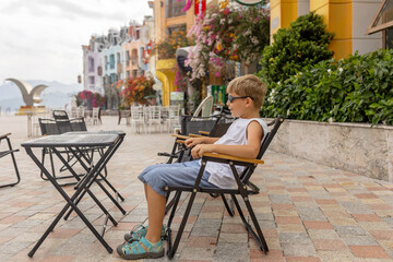 Family with children, visiting Vinpearl, island near Nha Trang, connected with a cable car, beautiful gothic buldings and colorful houses