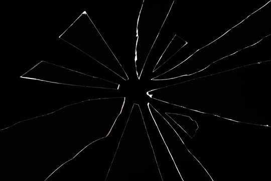 shards of broken glass on black background