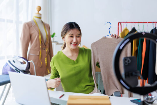 Fashion designer presenting clothes during online streaming video for social network followers