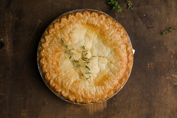 Homemade apple pie  with golden crust on rustic table