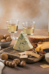 Blue cheese with berries and nuts on rustic background