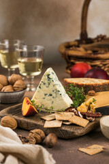 Blue cheese with berries and nuts on rustic background