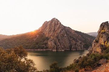 Sunset over the Salto del Gitano cliffs in Monfragüe National Park, Cáceres, Spain. Iconic rock formation and river landscape.