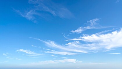 Wispy clouds drift across a vibrant azure sky