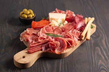 Charcuterie board. Antipasti appetizers of meat platter with salami, prosciutto crudo or jamon and olives.