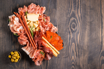 Charcuterie board. Antipasti appetizers of meat platter with salami, prosciutto crudo or jamon and olives.