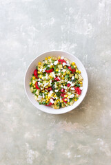 Pasta salad with tomatoes, zucchini, corn and feta cheese. Healthy eating. Vegetarian food.