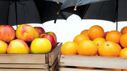 Wooden crates filled with fresh oranges and apples, great for still life photography or as a prop for food or market scenes