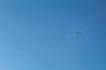 A jet airplane flying in the blue sky