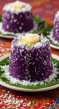 Purple rice cake with butter and shredded coconut on banana leaves Puto