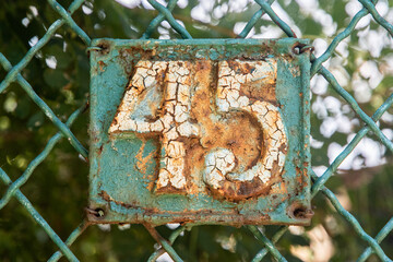 Old retro weathered cast iron plate with number 45