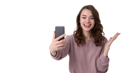 Fototapeta premium Young woman smiling while taking a selfie with her smartphone, isolated on white background.