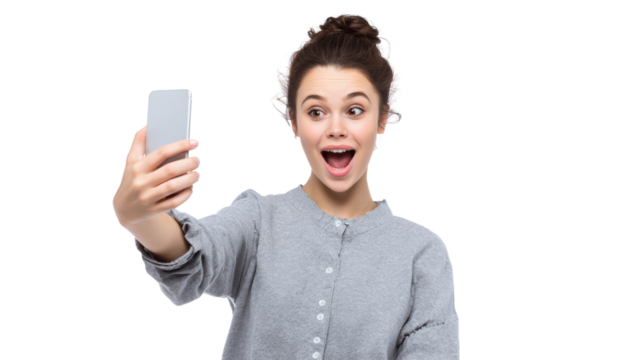 Young woman taking a selfie, expressing joy and excitement, on a white isolated background.