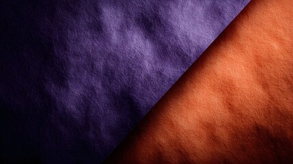 Abstract background with a diagonal split of rich purple and vibrant orange colors featuring a soft textured surface