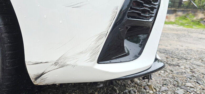 The right side of white car bumper has scratches that reveal black material inside. An accident where it was collision with car or scraped against the sidewalk. while road was slippery due to rain.
- Powered by Adobe