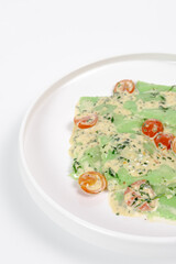 Green Vegan Ravioli with Creamy Sauce and Cherry Tomatoes