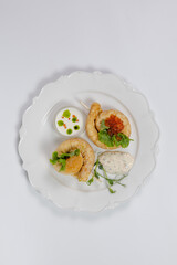 Top view of pancakes with red caviar in a restaurant on a white background. photo for the menu