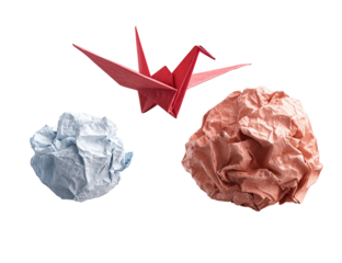 Origami crane above crumpled paper balls