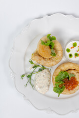 Top view of pancakes with red caviar in a restaurant on a white background. photo for the menu