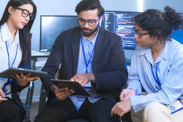 A diverse creative team brainstorms ideas in a meeting, using tablets for collaboration. Smiling professionals discuss a new UI/UX design for an app in a modern office.